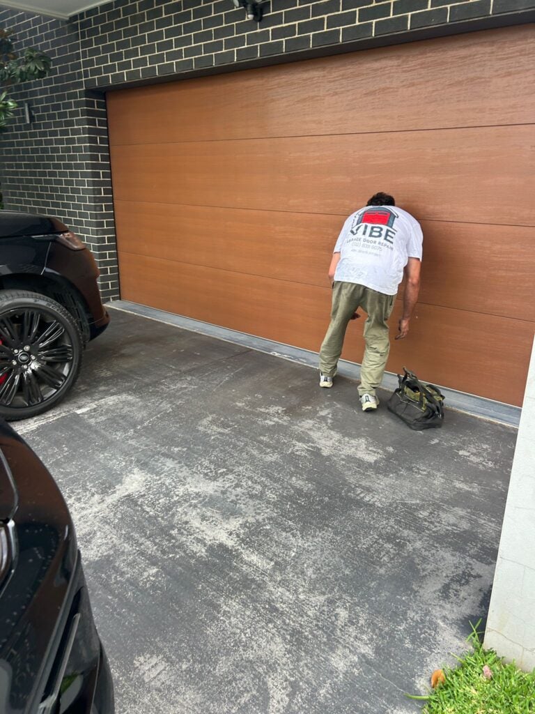 Vibe Garage Door Technician try to open stuck garage door